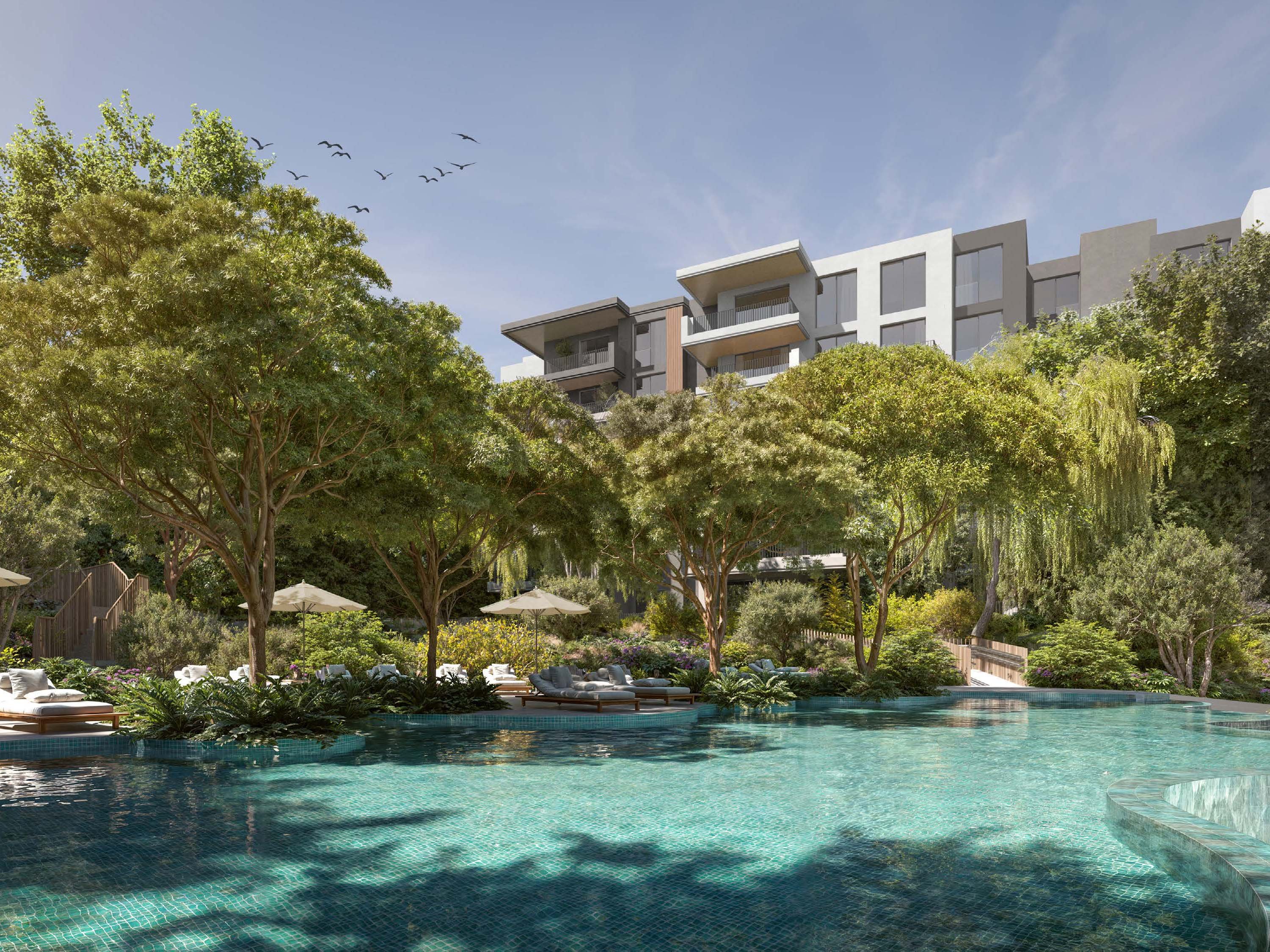 In Dubailand, Ghaf Woods by Majid Al Futtaim offers a blend of nature and urban life. This project includes 1 to 3-bedroom apartments with a focus on simple, clean design. The homes feature large windows that bring in natural light, and balconies that extend living spaces into the outdoors. Ghaf Woods at Dubailand integrates the calm of nature with the pulse of city life. Paths wind through green spaces, perfect for a walk or run. The nearby Global Village offers spots for dining and shopping, blending urban convenience with the peace of nature. Interiors at Ghaf Woods show a thoughtful use of space. The blend of sleek lines and natural materials creates a calm, balanced feel. Kitchens, bedrooms, and bathrooms come with quality fixtures, ensuring comfort and style. Residents enjoy a range of amenities. The fitness center and pool provide spaces to relax and stay active. There are areas for yoga and meditation, offering a retreat for the mind. Children have dedicated play areas, both indoors and outdoors.