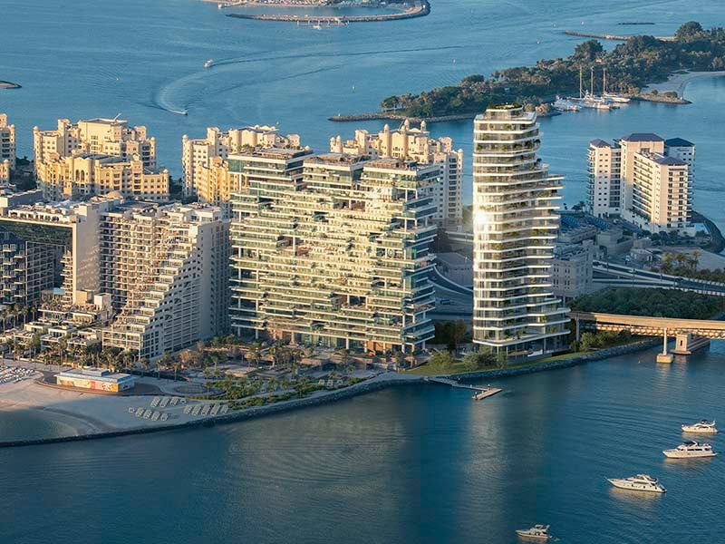 Ela Residences by Omniyat redefines ultra-luxury living on Palm Jumeirah. This exclusive collection of 3- and 4-bedroom apartments is crafted to embody the zenith of sophistication and privacy. Situated on one of the island’s most coveted plots, these residences offer sweeping views of the Arabian Gulf and the glittering Dubai skyline. Zaha Hadid's innovative architecture shapes Ela Residences with her signature style evident in the sweeping, fluid forms and cutting-edge aesthetics. Each residence features expansive terraces that seamlessly connect indoor living spaces with the serene outdoors. Floor-to-ceiling windows flood the interiors with natural light, enhancing the sense of openness and framing breathtaking vistas. The interiors, curated by the Dorchester Collection, reflect a commitment to luxury and refinement. Premium materials and bespoke finishes are meticulously chosen, creating spaces that are both elegant and functional. Each apartment is designed to offer a refined living experience where every detail contributes to an atmosphere of exclusivity and comfort. Located on the Eastern Crescent, Ela Residences offers direct beachfront access and panoramic views, providing a rare combination of privacy and prestige and setting a new standard for luxury living on Palm Jumeirah. Starting at AED 43M, Ela Residences by Omniyat offers 3- and 4-bedroom apartments. The handover is expected in Q1 2028 with a 60/40 payment plan.