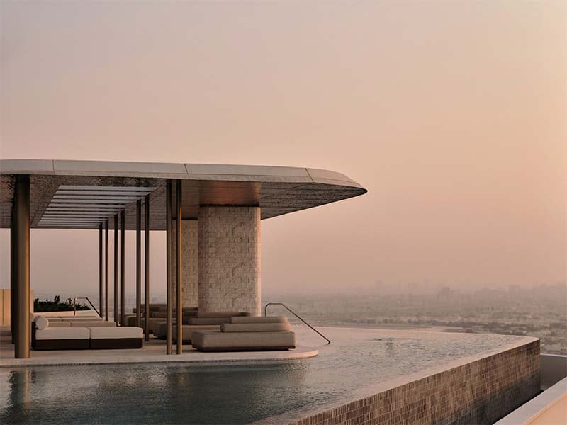 Ela Residences by Omniyat redefines ultra-luxury living on Palm Jumeirah. This exclusive collection of 3- and 4-bedroom apartments is crafted to embody the zenith of sophistication and privacy. Situated on one of the island’s most coveted plots, these residences offer sweeping views of the Arabian Gulf and the glittering Dubai skyline. Zaha Hadid's innovative architecture shapes Ela Residences with her signature style evident in the sweeping, fluid forms and cutting-edge aesthetics. Each residence features expansive terraces that seamlessly connect indoor living spaces with the serene outdoors. Floor-to-ceiling windows flood the interiors with natural light, enhancing the sense of openness and framing breathtaking vistas. The interiors, curated by the Dorchester Collection, reflect a commitment to luxury and refinement. Premium materials and bespoke finishes are meticulously chosen, creating spaces that are both elegant and functional. Each apartment is designed to offer a refined living experience where every detail contributes to an atmosphere of exclusivity and comfort. Located on the Eastern Crescent, Ela Residences offers direct beachfront access and panoramic views, providing a rare combination of privacy and prestige and setting a new standard for luxury living on Palm Jumeirah. Starting at AED 43M, Ela Residences by Omniyat offers 3- and 4-bedroom apartments. The handover is expected in Q1 2028 with a 60/40 payment plan.