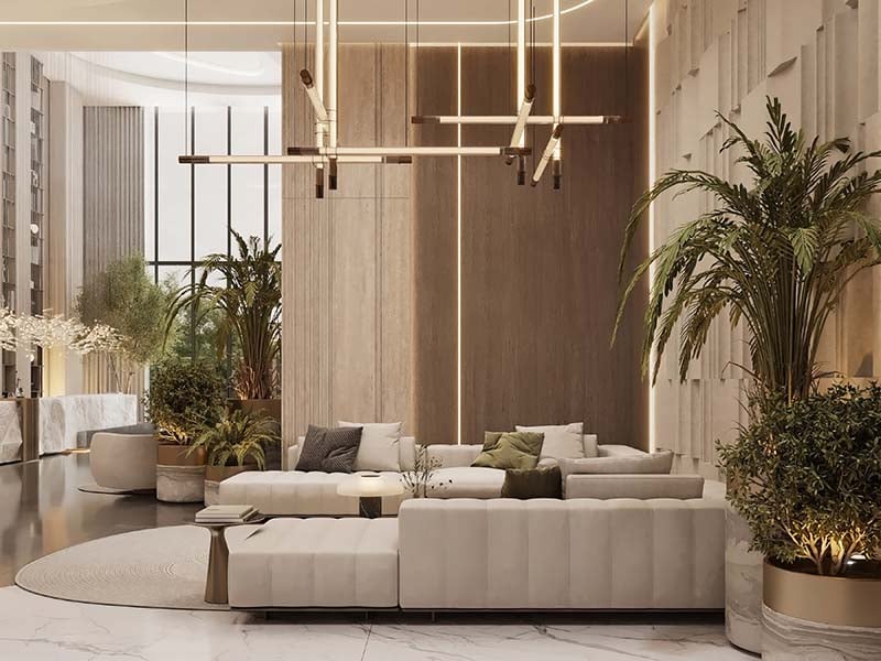 Cove by Imtiaz emerges in Dubailand as a vertical sanctuary. Its pearl white façade echoes the desert's timeless palette while its interiors redefine urban living. Within this tower, homes range from studios to two-bedroom retreats. Each space tells a story of thoughtful design. Kitchens become culinary stages with clean lines and intuitive layouts. Bathrooms transform into personal spas, marrying form and function. Bedrooms offer respite with views that frame Dubai's evolving skyline. Cove's true character unfolds in its shared spaces. An infinity pool seemingly merges with the horizon. For the active, a padel court awaits. A running track winds through the property, offering a path for morning jogs or evening strolls. Quieter moments find their place too. Serene cabanas offer pockets of tranquility. A yoga deck and a fully equipped gym, with its array of equipment, stand ready for those seeking a moment of calm or physical challenge. As day turns to evening, the open-air cinema flickers to life. Nearby, BBQ areas invite culinary experiments and social gatherings. Throughout Cove, green spaces create breathing room. These pockets of nature soften the urban edge, providing impromptu meeting spots or solitary retreats.