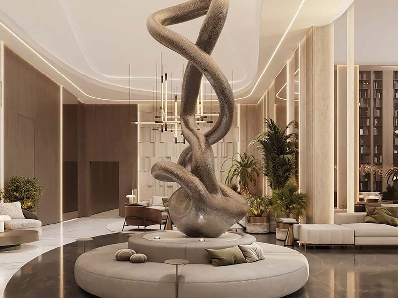 Cove by Imtiaz emerges in Dubailand as a vertical sanctuary. Its pearl white façade echoes the desert's timeless palette while its interiors redefine urban living. Within this tower, homes range from studios to two-bedroom retreats. Each space tells a story of thoughtful design. Kitchens become culinary stages with clean lines and intuitive layouts. Bathrooms transform into personal spas, marrying form and function. Bedrooms offer respite with views that frame Dubai's evolving skyline. Cove's true character unfolds in its shared spaces. An infinity pool seemingly merges with the horizon. For the active, a padel court awaits. A running track winds through the property, offering a path for morning jogs or evening strolls. Quieter moments find their place too. Serene cabanas offer pockets of tranquility. A yoga deck and a fully equipped gym, with its array of equipment, stand ready for those seeking a moment of calm or physical challenge. As day turns to evening, the open-air cinema flickers to life. Nearby, BBQ areas invite culinary experiments and social gatherings. Throughout Cove, green spaces create breathing room. These pockets of nature soften the urban edge, providing impromptu meeting spots or solitary retreats.