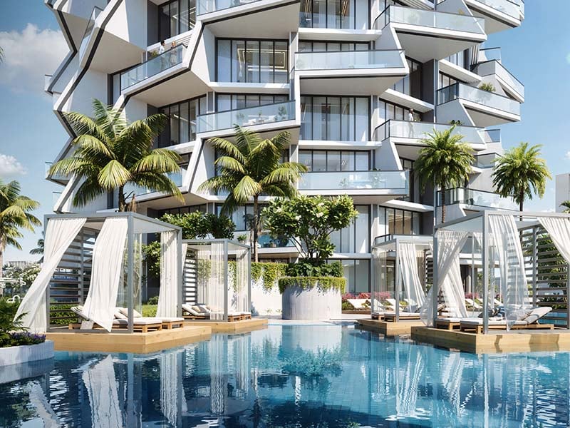 Binghatti Grove by Binghatti Developers offers a luxurious selection of 1 to 3-bedroom apartments in the family-friendly community of Jumeirah Village Circle (JVC). These off-plan apartments combine biophilic design with contemporary elegance, creating a unique blend of comfort and sustainability. Each residence features eco-friendly materials and sustainable facades, offering a mindful living environment for modern Dubai. The project provides an array of exceptional amenities, including a serene pool deck, outdoor yoga area, sports courts, and dedicated kids’ play areas. Residents can also enjoy an outdoor fitness zone and paddle courts, making it perfect for those looking to lead an active lifestyle. Additionally, the development offers stunning views of the surrounding green spaces, enhancing the overall living experience. Binghatti Grove’s prime location in JVC ensures easy access to Al Khail Road and Sheikh Mohammed Bin Zayed Road, allowing residents to reach key destinations like Downtown Dubai, Dubai Marina, and Dubai International Airport in under 25 minutes. The proximity to Circle Mall, parks, schools, and healthcare facilities adds further convenience for families and professionals. Starting at AED 1.2M, Binghatti Grove at JVC offers 1 to 3-bedroom apartments. The handover is expected in Q4 2026 with a 70/30 payment plan.