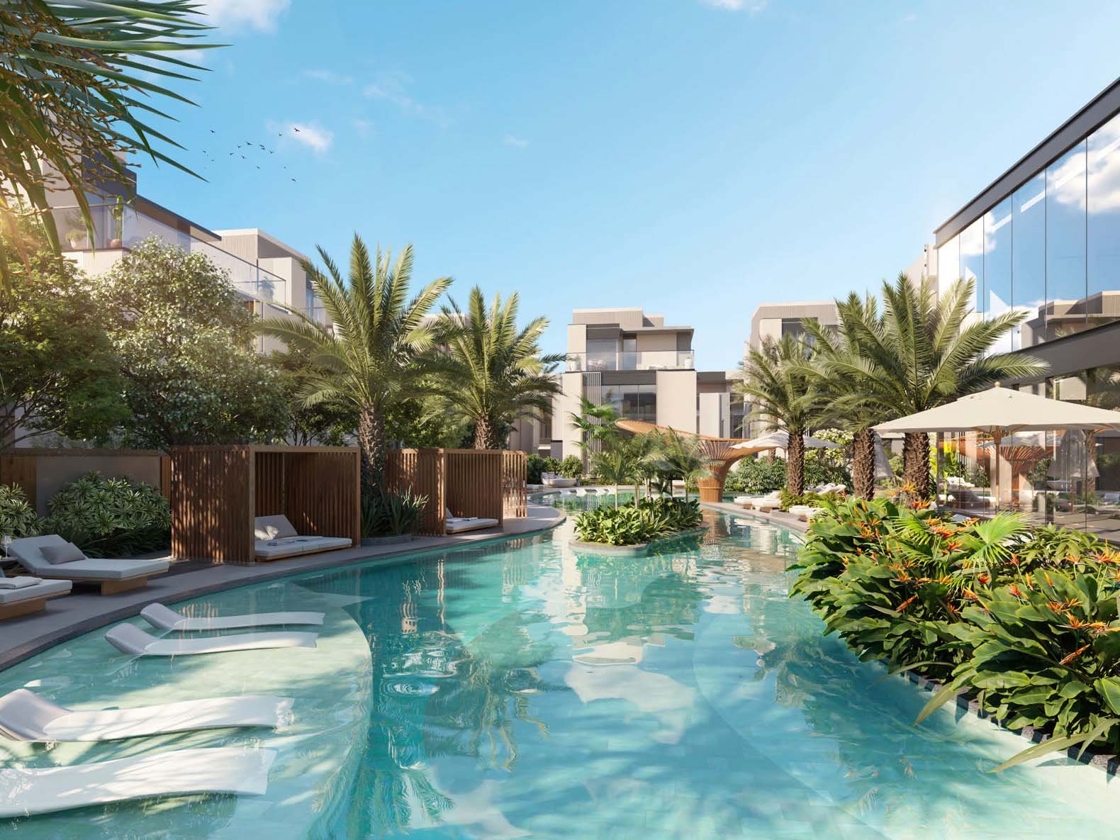 Ellington Properties unveils The Watercrest, a new addition to Mohammed Bin Rashid City. The community is defined by its flowing water features which elegantly merge with beautifully landscaped green spaces and gracefully curved pathways. Three distinct neighborhoods form The Watercrest. The Riverine offers 31 homes, each embracing the water's edge. The Alcove, with 25 units, provides intimate spaces for those who value privacy. The Arcadia rounds out the community with 28 residences, balancing openness and seclusion. Townhouses and villas stand in harmony with their surroundings. Three-bedroom townhouses flow from room to room while four-bedroom villas expand possibilities for family life. Large windows frame ever-changing views of gardens and water features. Inside, materials engage the senses. Wood warms underfoot, stone cools to the touch. Light plays across surfaces, shifting moods from dawn to dusk. Outdoor spaces become natural extensions of home from cozy balconies to spacious gardens. A river club anchors community life, its plunge pool a gathering point on warm days. Fitness and yoga studios promote well-being while an outdoor cinema brings neighbors together under the stars. Children find their own spaces in play areas and a dedicated kids' club.