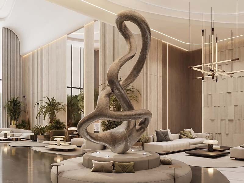 Cove by Imtiaz emerges in Dubailand as a vertical sanctuary. Its pearl white façade echoes the desert's timeless palette while its interiors redefine urban living. Within this tower, homes range from studios to two-bedroom retreats. Each space tells a story of thoughtful design. Kitchens become culinary stages with clean lines and intuitive layouts. Bathrooms transform into personal spas, marrying form and function. Bedrooms offer respite with views that frame Dubai's evolving skyline. Cove's true character unfolds in its shared spaces. An infinity pool seemingly merges with the horizon. For the active, a padel court awaits. A running track winds through the property, offering a path for morning jogs or evening strolls. Quieter moments find their place too. Serene cabanas offer pockets of tranquility. A yoga deck and a fully equipped gym, with its array of equipment, stand ready for those seeking a moment of calm or physical challenge. As day turns to evening, the open-air cinema flickers to life. Nearby, BBQ areas invite culinary experiments and social gatherings. Throughout Cove, green spaces create breathing room. These pockets of nature soften the urban edge, providing impromptu meeting spots or solitary retreats.