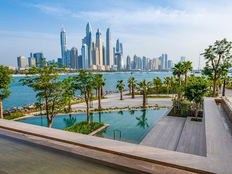 Ela Residences by Omniyat redefines ultra-luxury living on Palm Jumeirah. This exclusive collection of 3- and 4-bedroom apartments is crafted to embody the zenith of sophistication and privacy. Situated on one of the island’s most coveted plots, these residences offer sweeping views of the Arabian Gulf and the glittering Dubai skyline. Zaha Hadid's innovative architecture shapes Ela Residences with her signature style evident in the sweeping, fluid forms and cutting-edge aesthetics. Each residence features expansive terraces that seamlessly connect indoor living spaces with the serene outdoors. Floor-to-ceiling windows flood the interiors with natural light, enhancing the sense of openness and framing breathtaking vistas. The interiors, curated by the Dorchester Collection, reflect a commitment to luxury and refinement. Premium materials and bespoke finishes are meticulously chosen, creating spaces that are both elegant and functional. Each apartment is designed to offer a refined living experience where every detail contributes to an atmosphere of exclusivity and comfort. Located on the Eastern Crescent, Ela Residences offers direct beachfront access and panoramic views, providing a rare combination of privacy and prestige and setting a new standard for luxury living on Palm Jumeirah. Starting at AED 43M, Ela Residences by Omniyat offers 3- and 4-bedroom apartments. The handover is expected in Q1 2028 with a 60/40 payment plan.