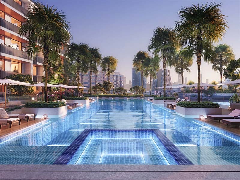 Aurora by Binghatti at Jumeirah Village Circle unfolds a new chapter in urban living. This project introduces a blend of simplicity and precision, seamlessly integrating with its surroundings. The design resonates with the rhythm of city life while creating a tranquil space for its residents. Aurora brings together form and function. The clean lines of its architecture are a testament to thoughtful design, aiming for a seamless blend with the cityscape. The facade engages with the skyline while providing a calm backdrop for residents. Inside, Aurora offers a range of living spaces from studios to 1-2 bedroom apartments. Each unit is crafted to enhance everyday life, maximizing natural light and providing a sense of openness. The interiors are designed with practicality in mind, balancing comfort with simplicity. The amenities at Aurora are tailored to support a balanced lifestyle. From the pools for all ages to the yoga area and fitness facilities, each element is positioned to foster well-being. Green spaces and relaxation areas invite residents to enjoy moments of peace amidst the city's rhythm.