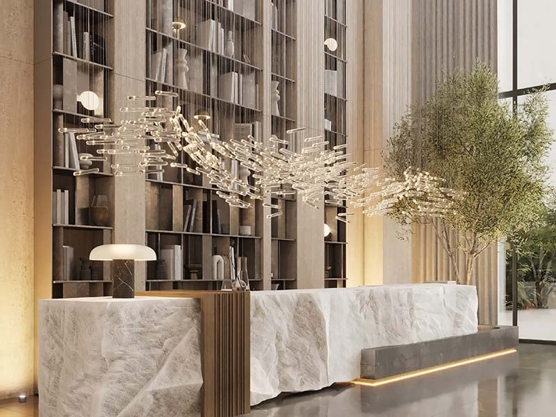 Cove by Imtiaz emerges in Dubailand as a vertical sanctuary. Its pearl white façade echoes the desert's timeless palette while its interiors redefine urban living. Within this tower, homes range from studios to two-bedroom retreats. Each space tells a story of thoughtful design. Kitchens become culinary stages with clean lines and intuitive layouts. Bathrooms transform into personal spas, marrying form and function. Bedrooms offer respite with views that frame Dubai's evolving skyline. Cove's true character unfolds in its shared spaces. An infinity pool seemingly merges with the horizon. For the active, a padel court awaits. A running track winds through the property, offering a path for morning jogs or evening strolls. Quieter moments find their place too. Serene cabanas offer pockets of tranquility. A yoga deck and a fully equipped gym, with its array of equipment, stand ready for those seeking a moment of calm or physical challenge. As day turns to evening, the open-air cinema flickers to life. Nearby, BBQ areas invite culinary experiments and social gatherings. Throughout Cove, green spaces create breathing room. These pockets of nature soften the urban edge, providing impromptu meeting spots or solitary retreats.